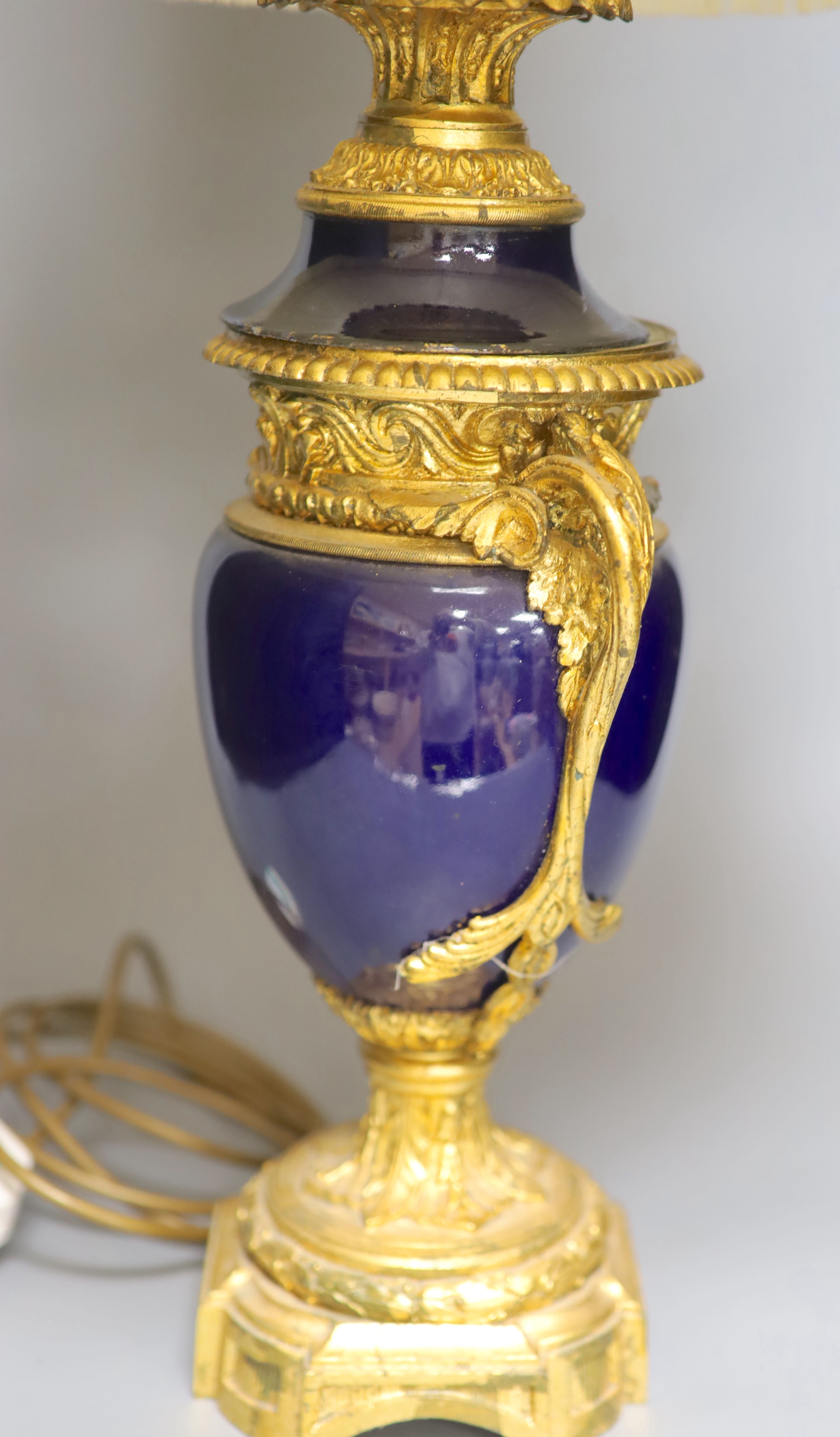 A French gilt metal and porcelain table lamp